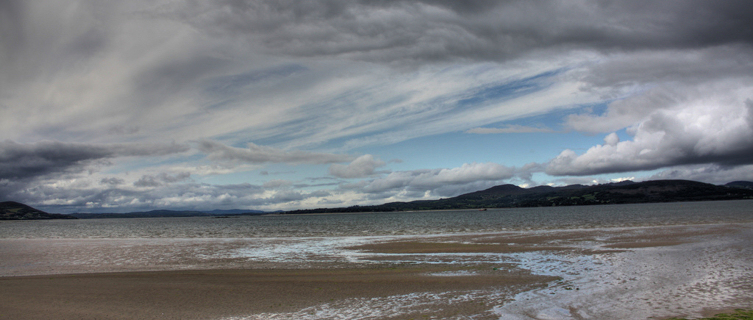 Buncrana's beach is surrounded by brooding mountains