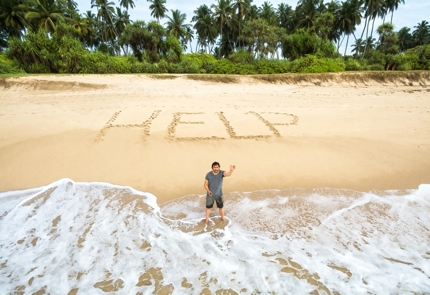 Carve 'HELP' into the sand in the biggest letters you can manage